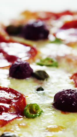 Baked-pizza-with-avocado,-cherry-tomato-and-olive-toppings