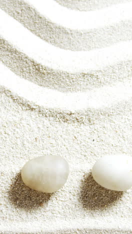 Various-pebble-stone-arranged-on-sand