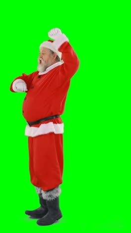 Santa-claus-dancing-against-green-background