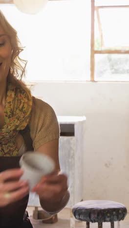 Female-potter-using-digital-tablet-while-working