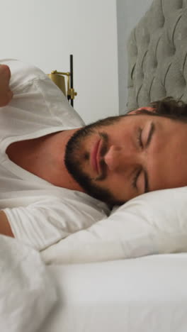 Young-man-sleeping-on-his-bed