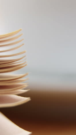 Close-up-of-coffee-cup-with-open-book