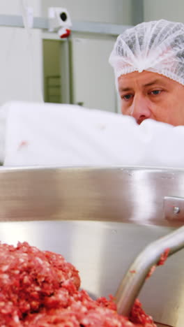 Butcher-preparing-minced-meat