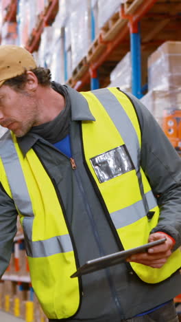 Warehouse-worker-looking-at-packages