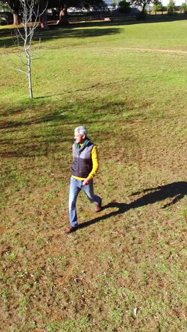 Man-walking-in-park-during-autumn