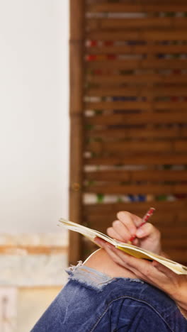 Beautiful-female-potter-painting-on-pot