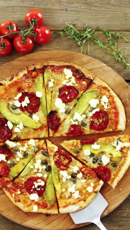 Delicious-pizza-with-ingredients-on-wooden-table