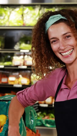 Smiling-female-staff-interacting-with-colleague-in-organic-section