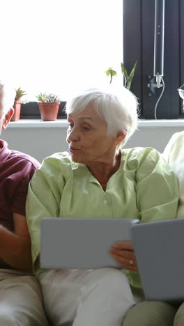 Senior-citizens-using-digital-tablet,-mobile-phone-and-laptop