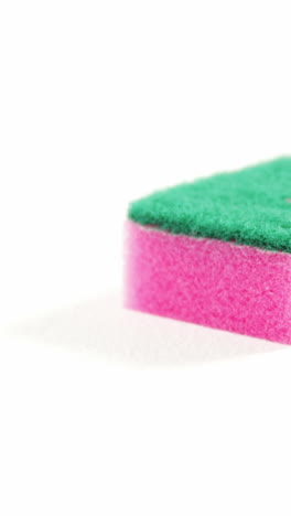 Plastic-cleaning-sponge-falling-on-white-background