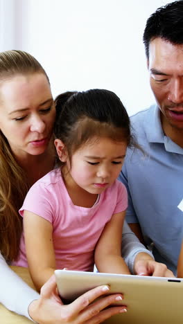 Happy-family-using-digital-tablet-in-living-room