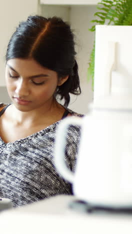 Woman-using-digital-tablet-in-kitchen