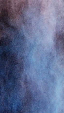 Blue-and-red-dust-powder-blowing-against-black-background