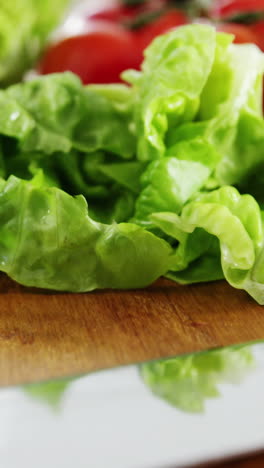 Vegetables-and-kitchen-knife-on-wooden-table