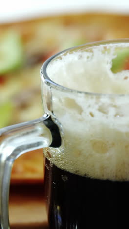 Delicious-pizza-with-glasses-of-beer-and-soft-drink