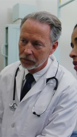 Surgeon-and-colleague-discussing-computer