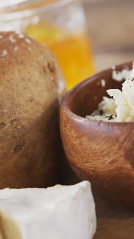 Loaf-of-bread-with-cheese,-knife-and-jam