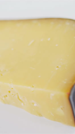 Slice-of-cheese-on-white-background