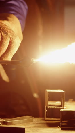 Welder-holding-welding-torch