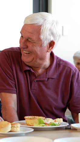 Senior-couple-interacting-with-each-other-while-having-breakfast