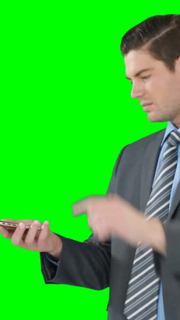 Young-businessman-gesturing-while-using-mobile-phone