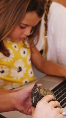 School-kids-using-laptop-in-classroom