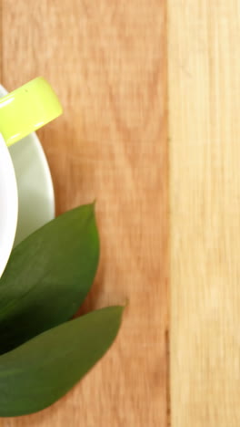 Close-up-of-tea-cup-with-saucer-and-tea-leaves