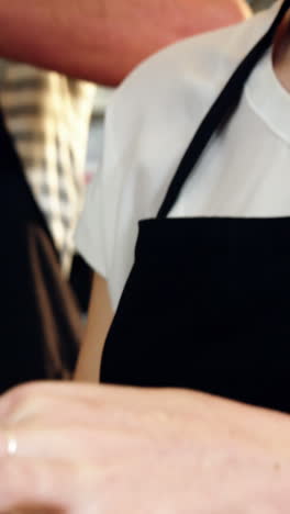 Waitress-wrapping-sandwich-with-a-wax-paper