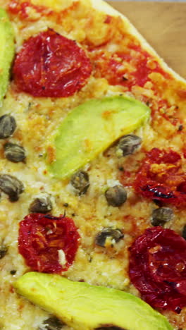 Baked-pizza-with-avocado,-cherry-tomato-and-olive-toppings