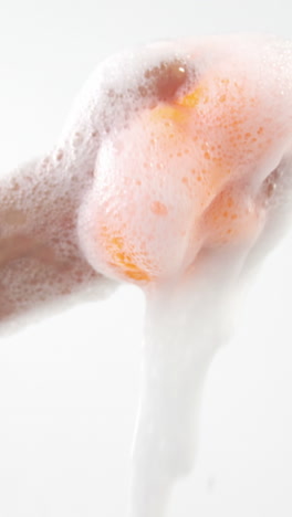 Close-up-of-hand-squeezing-cleaning-sponge