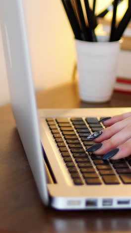 Mujer-Usando-Una-Computadora-Portátil-Mientras-Toma-Una-Taza-De-Café