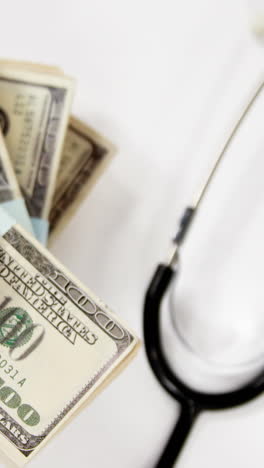 Stack-bundles-of-hundred-dollar-currency-with-a-stethoscope