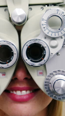 Optometrist-examining-female-patient-on-phoropter