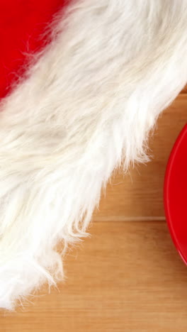 Close-up-of-coffee-cup-with-saucer-and-santa-hat