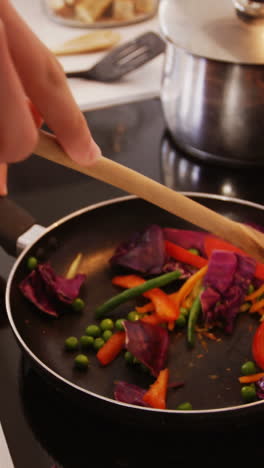 Man-preparing-a-food-in-kitchen