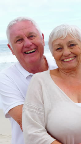 Senior-couple-embracing-each-other-on-the-beach