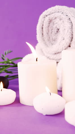 Pebbles,-candle,-towel-and-flowers