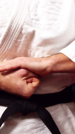 Man-preparing-for-karate-practice-in-fitness-studio