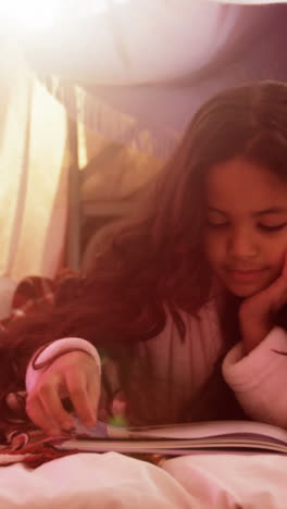 Girl-relaxing-on-mattress-and-reading-book