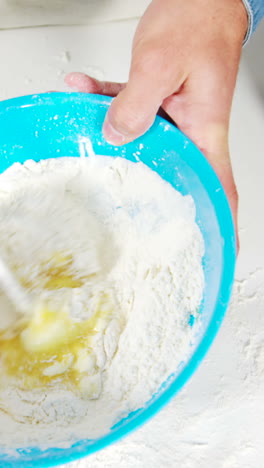 Father-and-son-preparing-cupcake