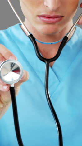 Close-up-of-male-surgeon-checking-with-stethoscope