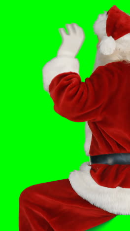 Rear-view-of-santa-claus-waving-hand