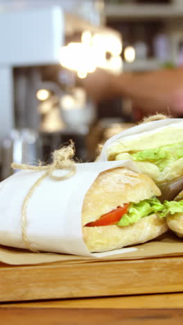 Waitress-arranging-sandwiches-on-counter