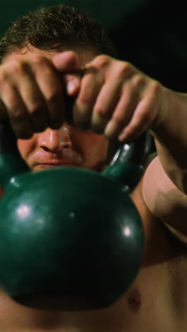 Muscular-man-lifting-kettle-bell