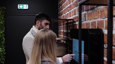 Slow-motion-shot-of-a-couple-entering-their-names-onto-a-digital-system