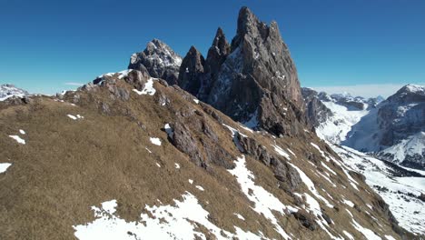 Aerial-View-of-Seceda-Mountain-Peak,-Italian-Dolomites-on-Sunny-Spring-Day,-Drone-Shot