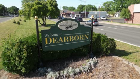 Welcome-to-Dearborn,-Michigan-sign-with-drone-video-moving-up