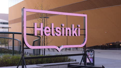 Pink-Helsinki-city-name-signage-outside-modern-Helsinki-Central-Library-Oodi