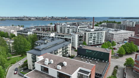 Drone-shot-low-over-apartments-in-Lauttasaari,-sunny,-summer-day-in-Helsinki