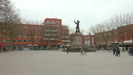 A-quiet-day-at-Place-Jean-Bart-in-Dunkirk-with-a-statue-and-people-walking-around